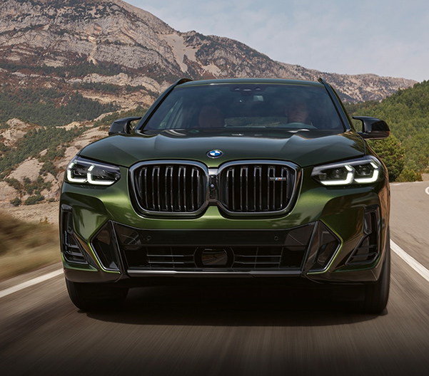 2023 BMW X3 front view driving on a highway