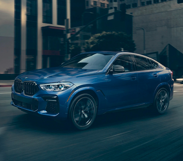 The 2023 BMW X6 driving on a city street