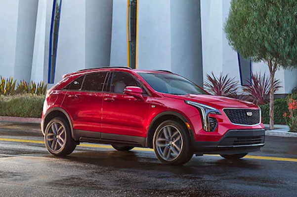 2023 Cadillac XT4 parked in front of lot with foliage