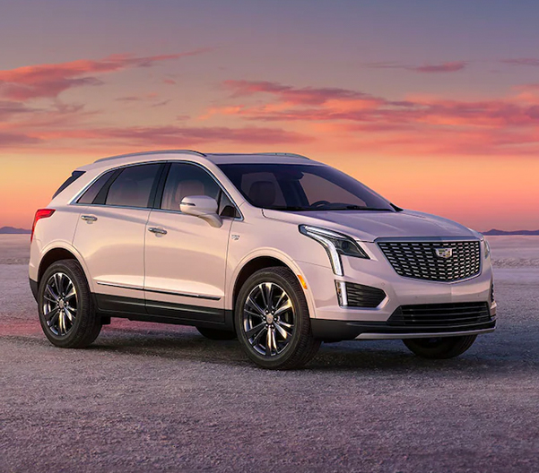 The 2023 Cadillac XT5 parked with mountains in the background