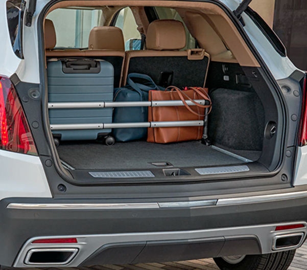 Opened trunk of the 2023 Cadillac XT5 with a suitcase inside