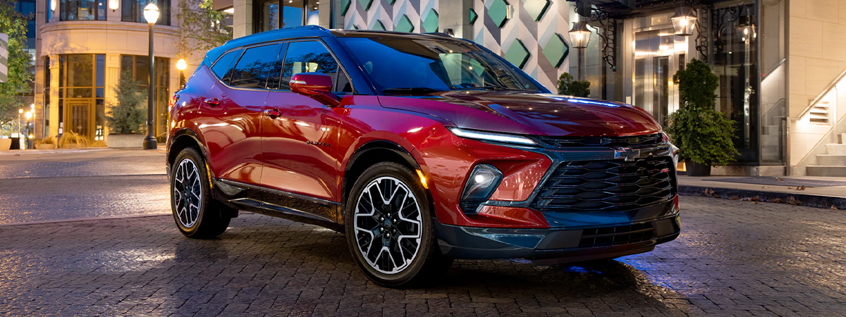 The 2023 Radiant Red Tintcoat Chevy Blazer Parked at Night in the City