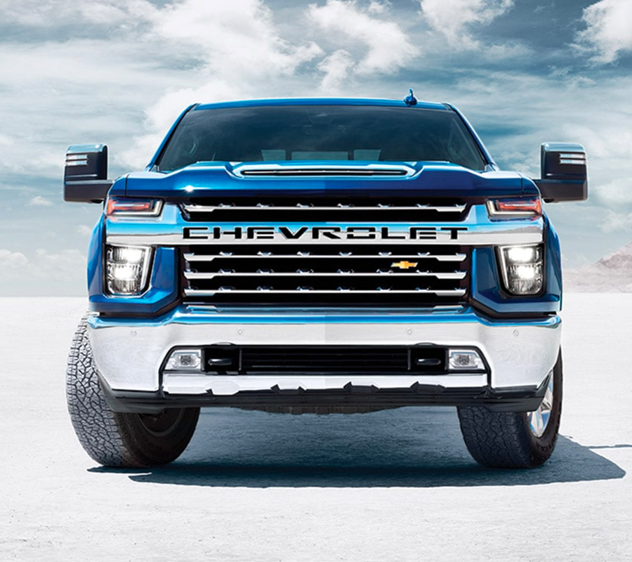 Blue 2023 Chevrolet Silverado head on shot on salt flats.