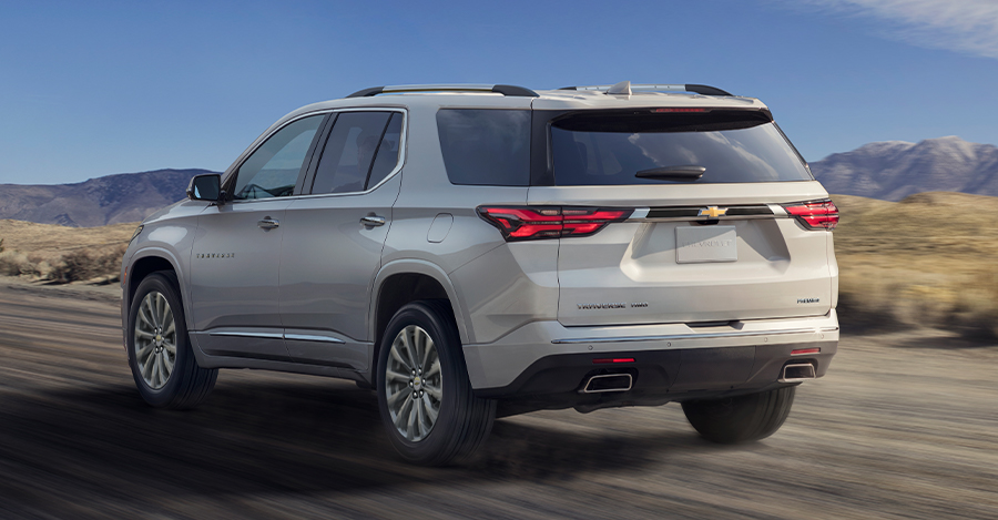 Chevy Traverse driving across mountain landscape with cloudy sky