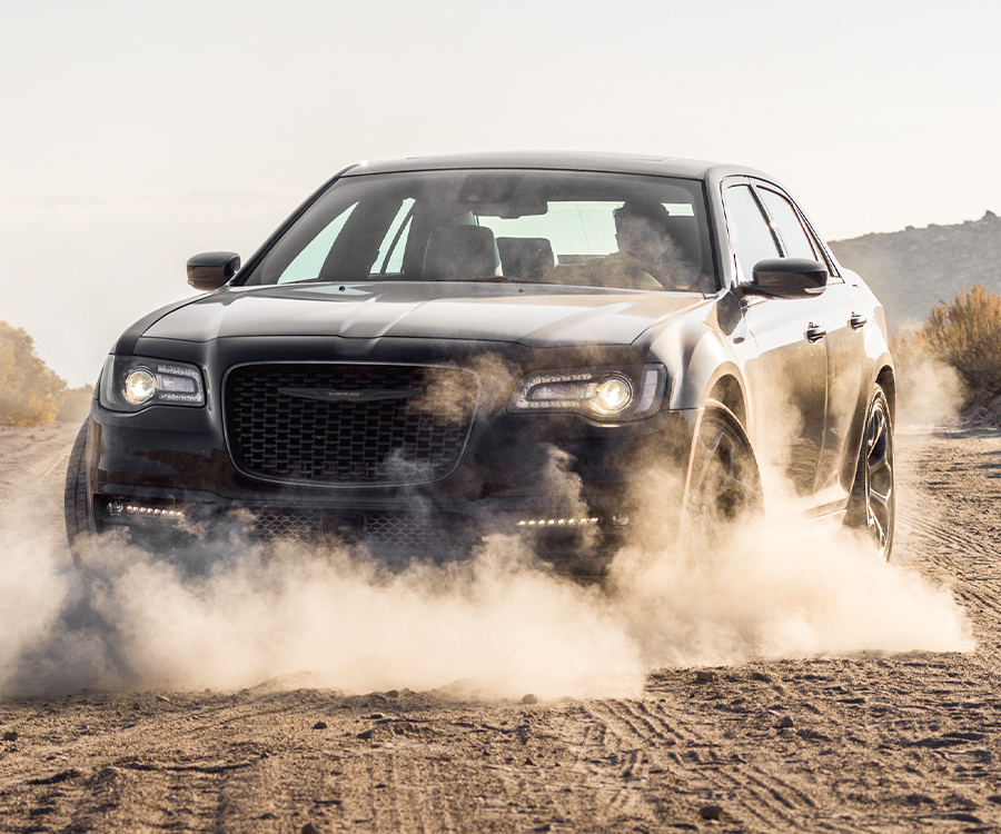 2023 300 Touring L with Sport Appearance Package in Gloss Black, kicking up dust while driving on dirt road in the desert.