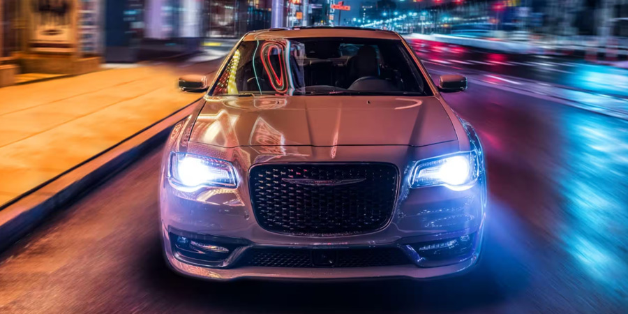 2023 Chrysler 300 driving in the city at night.