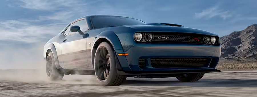 Display A low-lying angle of a 2023 Dodge Challenger R/T being driven on a track.