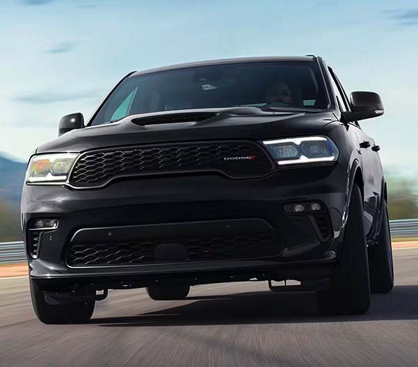 Exterior shot of a black 2023 Dodge Durango driving on a street.