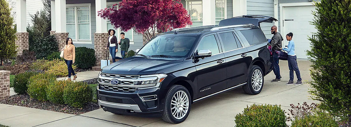 Ford Expedition parked in driveway with family