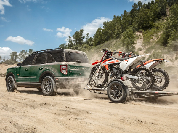 Exterior shot of a 2023 Ford Bronco Sport towing two dirtbikes.