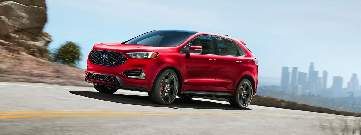Front view of red Ford Edge driving down road