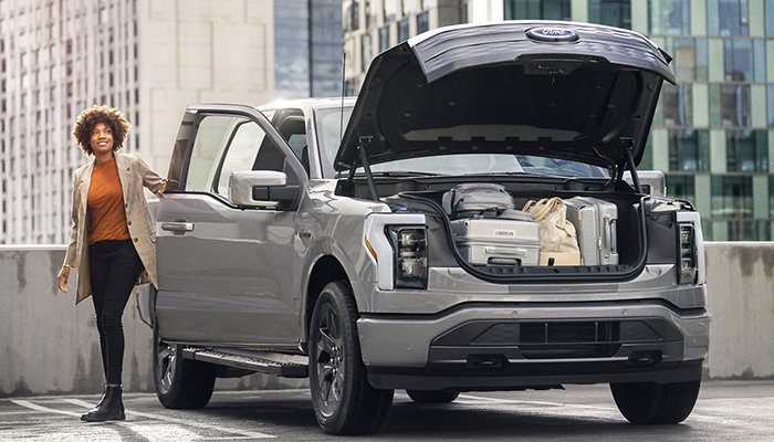 A 2023 Ford F-150 Lightning® parked on rooftop with Mega Power Frunk open and full of stuff