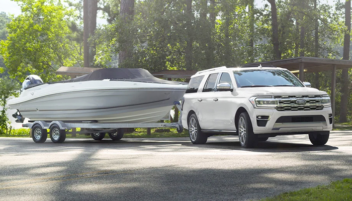 A 2023 Ford Expedition SUV towing a boat