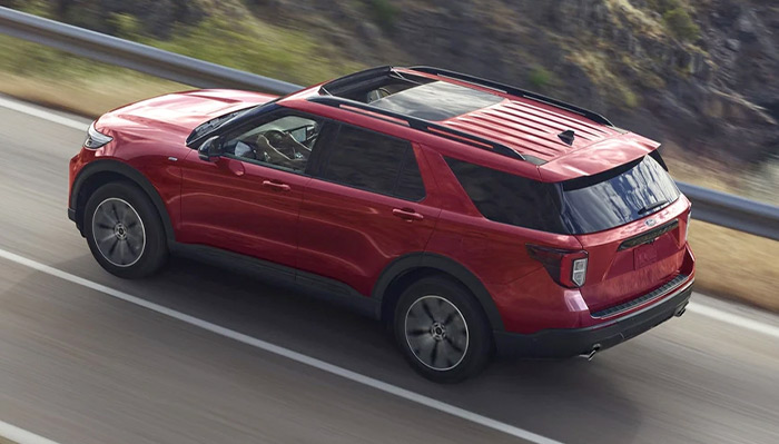 2023 Ford Explorer® ST Line model being driven on a lakeside highway