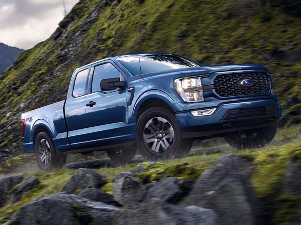 Exterior shot of a 2023 Ford F-150 driving up a mountain.