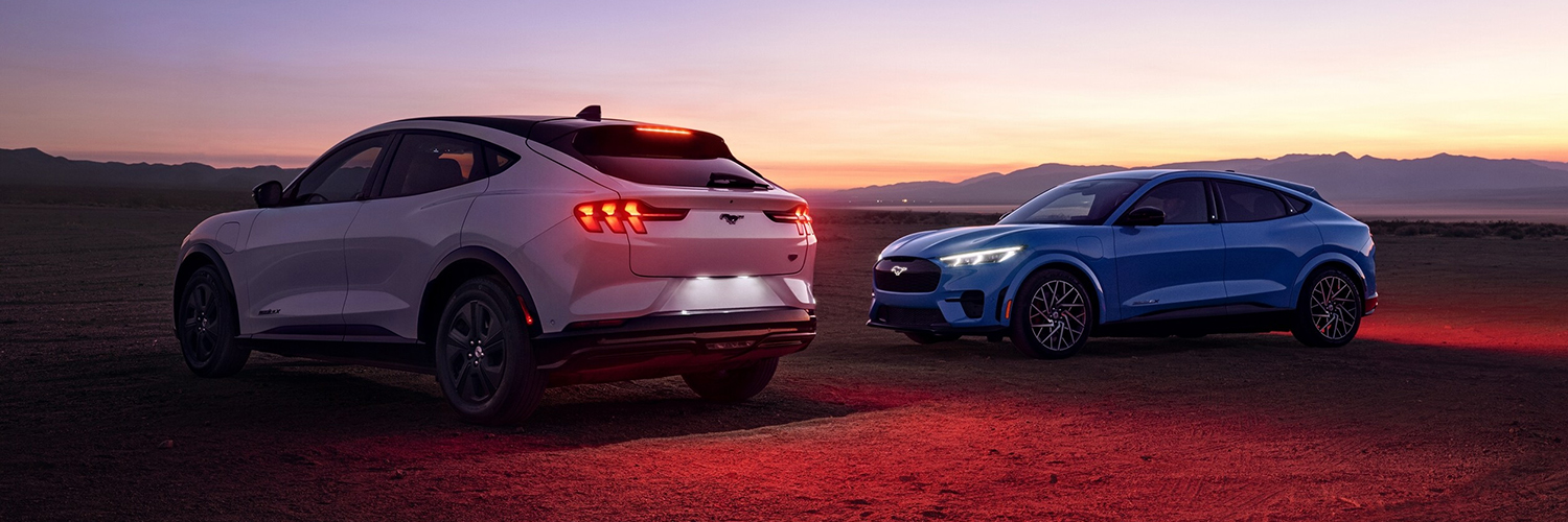 Two 2023 Ford Mustang Mach-E® parked in a desert at dusk