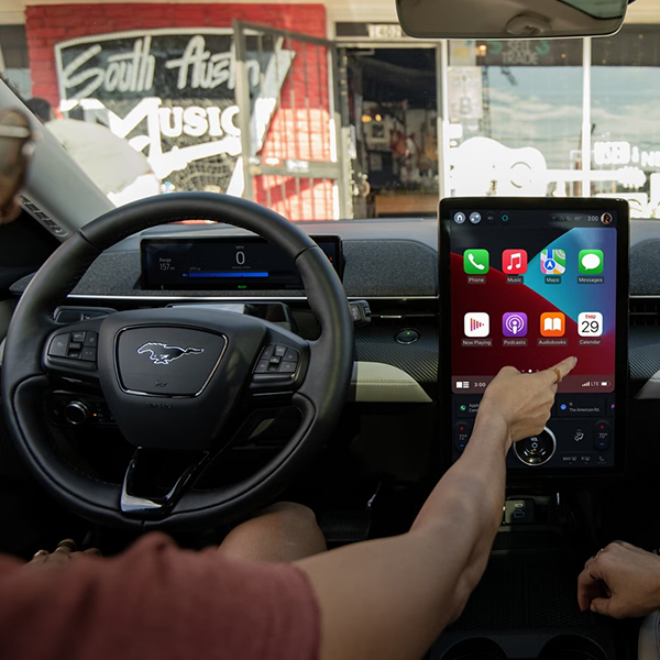 Person using the 15.5-inch touchscreen in a 2023 Ford Mustang Mach-E®