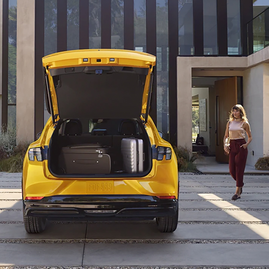 Rear end of the 2023 Ford Mustang Mach-EĀ® parked in a driveway with trunk open