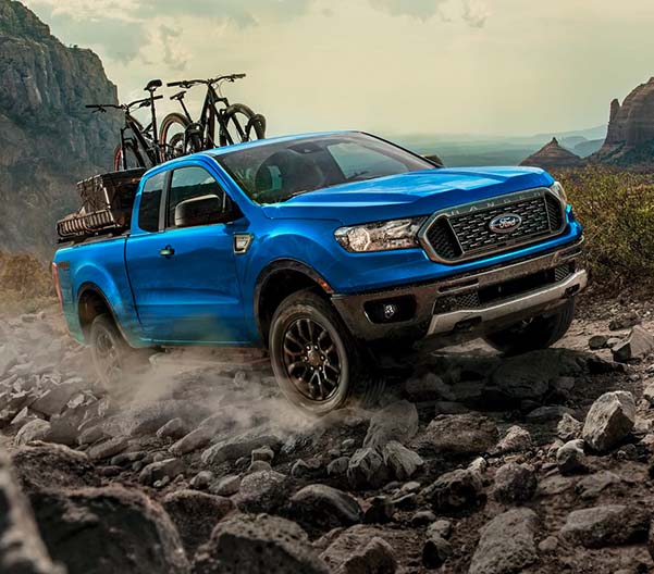 2023 Ford Ranger off-rading with mountain bikes and gear loaded in the bed