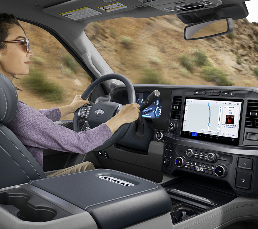 A woman sitting in the drivers seat of a 2023 Ford Super Duty®