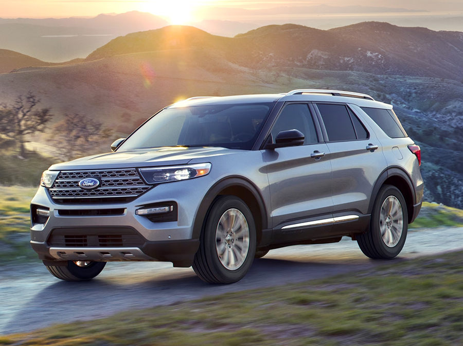 The 2023 Ford Explorer driving on a road with mountains in the background