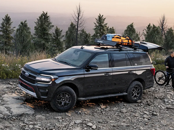 The 2023 Ford Expedition parked on a dirt road with the trunk opened