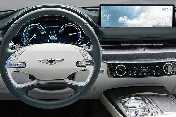 Close up of steering wheel and navigation touch screen in the 2023 Genesis G80