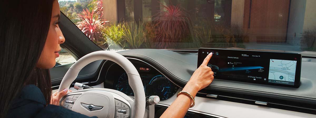 Genesis driver navigating the touchscreen display