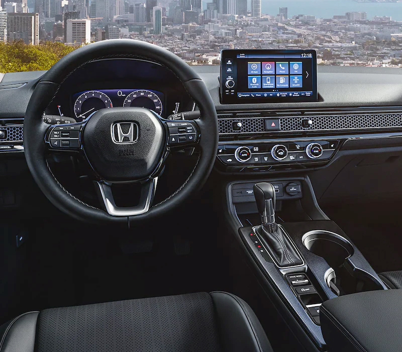 Interior view of the 2023 Honda Civic Touring Sedan with Black Leather, with a city skyline visible through the windshield.