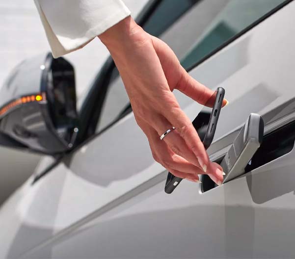 A detail shot of a person using a Hyundai Digital Key to unlock a 2023 IONIQ 5.