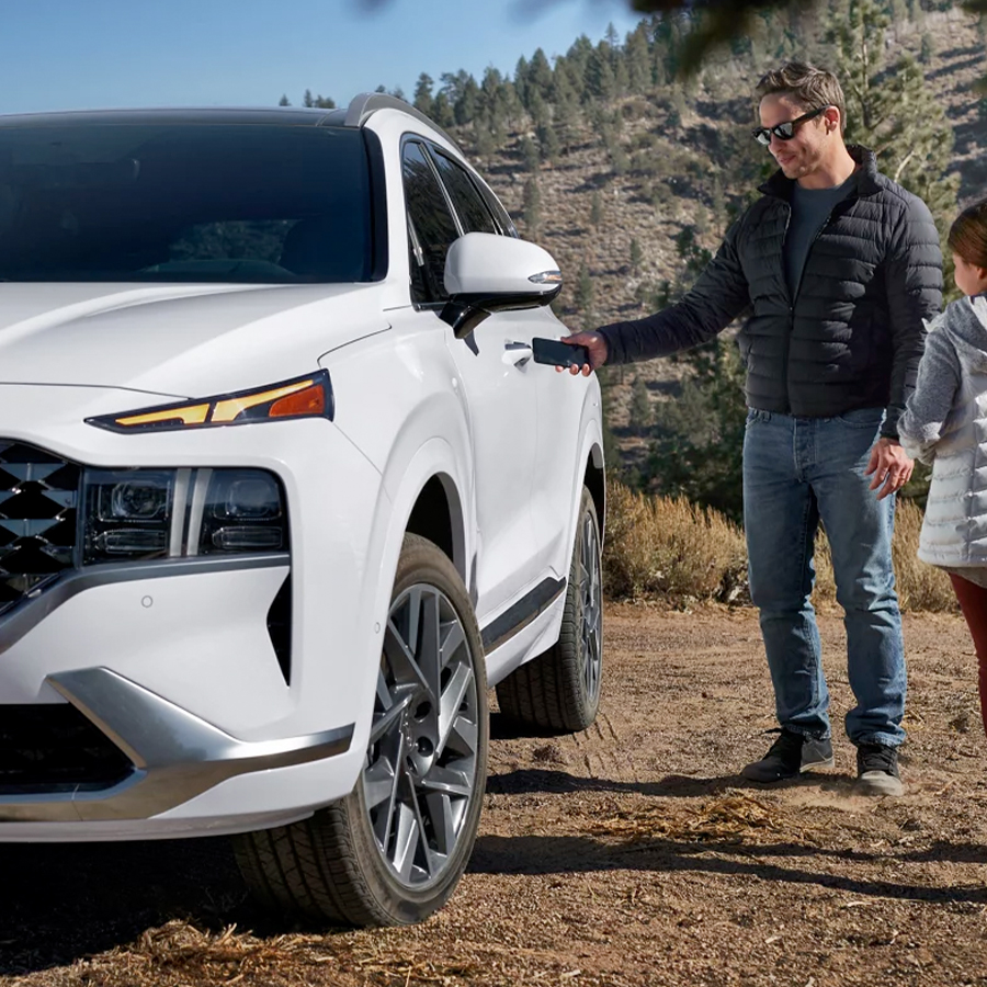 Father and daughter pictured with a 2023 Hyundai Santa Fe
