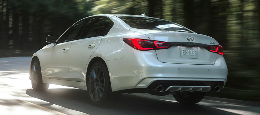 Rear profile view of 2023 INFINITI Q50 highlighting rear lights and performance-inspired exterior design