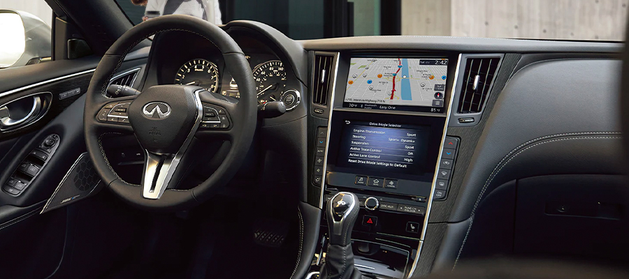 Interior view of 2023 INFINITI Q50 highlighting the driver console and gear shifter