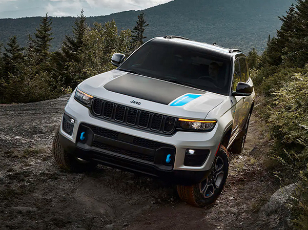 The 2023 Jeep Grand Cherokee 4xe being driven on a dirt trail.