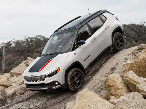A 2023 Jeep Compass Trailhawk descending a very steep hill off-road.