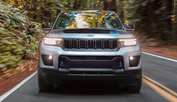 The 2023 Jeep Grand Cherokee 4XE driving along a country road