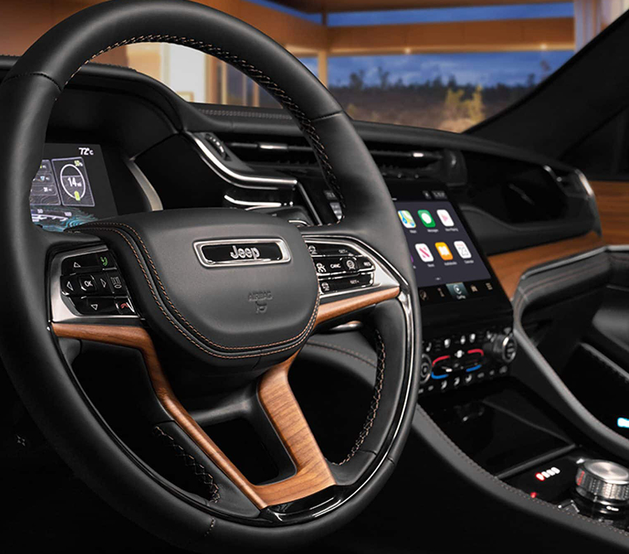 A close-up of the steering wheel in the 2023 Jeep Grand Cherokee Summit Reserve.