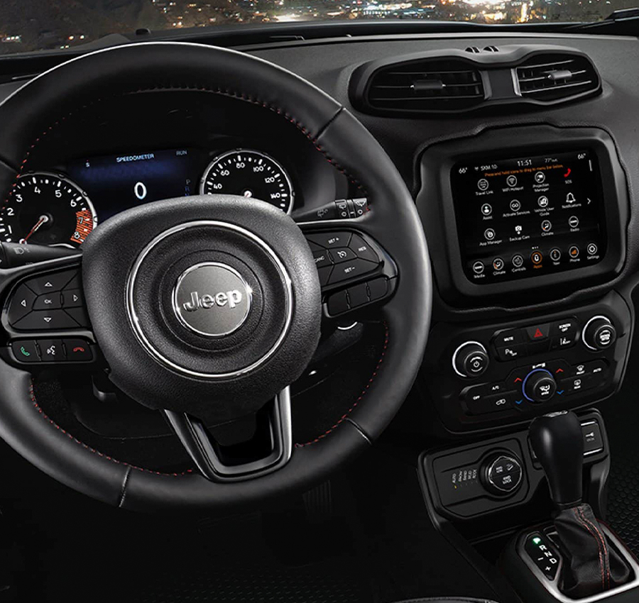 The interior of the 2023 Jeep Renegade focusing on the steering wheel, Digital Cluster Display, Uconnect touchscreen, center stack and dashboard.
