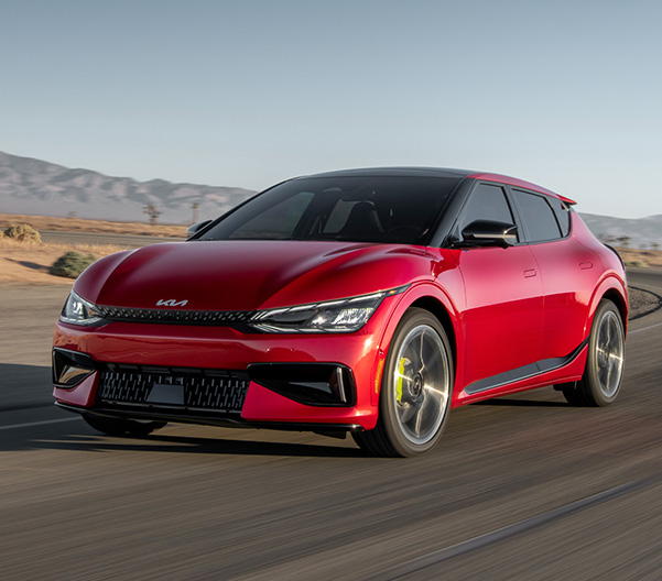 2023 Kia EV6 Driving Fast On A Desert Road Three-Quarter View