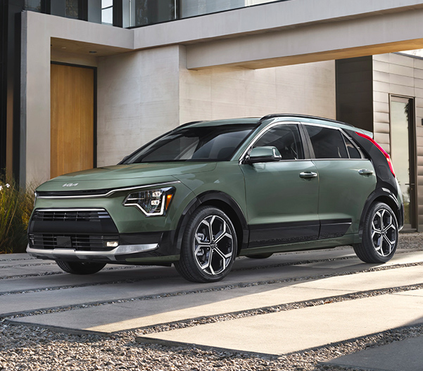 Front 3/4 shot of the 2023 Kia Niro Hybrid parked in front of modern house