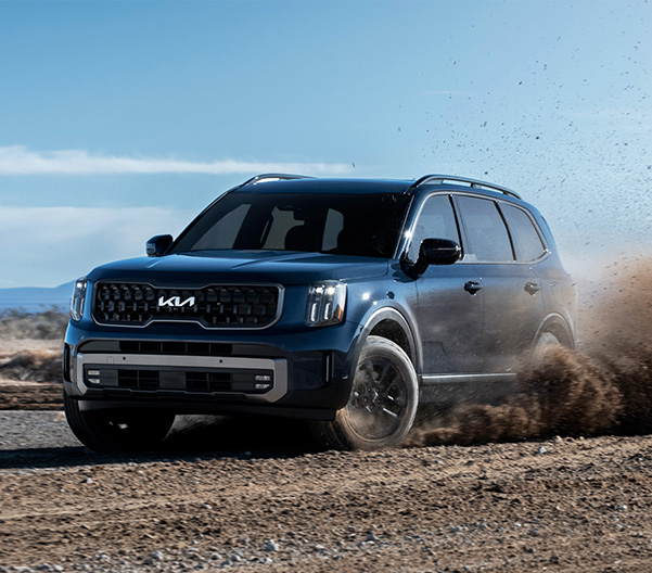 2023 Kia Telluride X-Pro Driving Off Road Through Dirt Three-Quarter View
