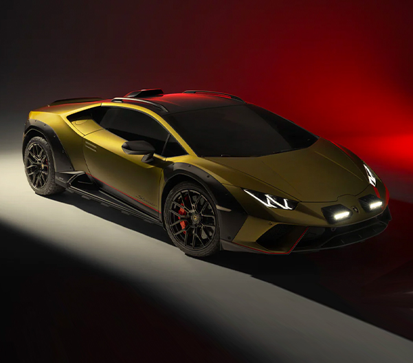 Front overhead 3/4 shot of Lamborghini Huracán Sterrato with red lighting background.