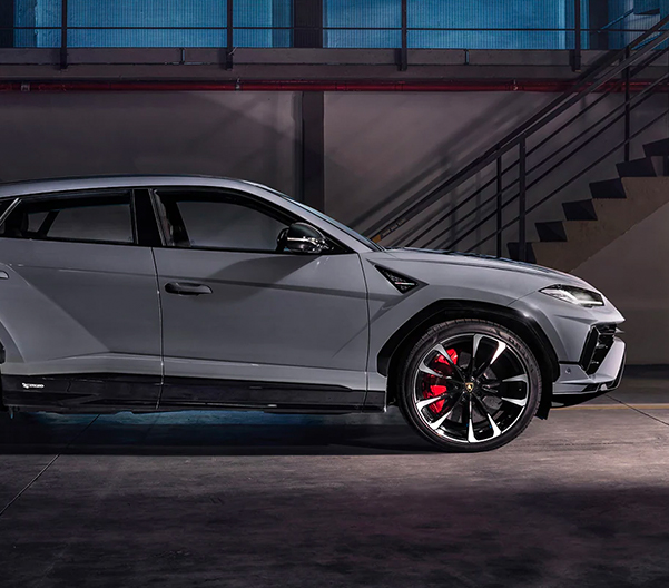 An exterior side shot of a New Lamborghini Urus S parked.