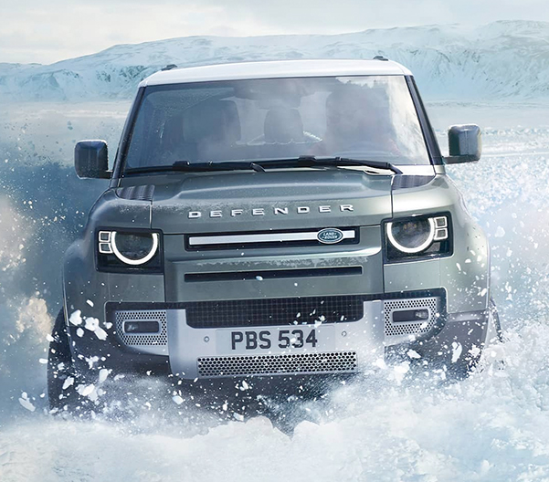2023 Land Rover Defender driving through snow (European model shown.)