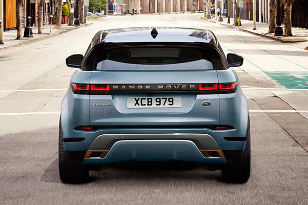 Rear shot of a 2023 Range Rover Evoque driving on a city street.