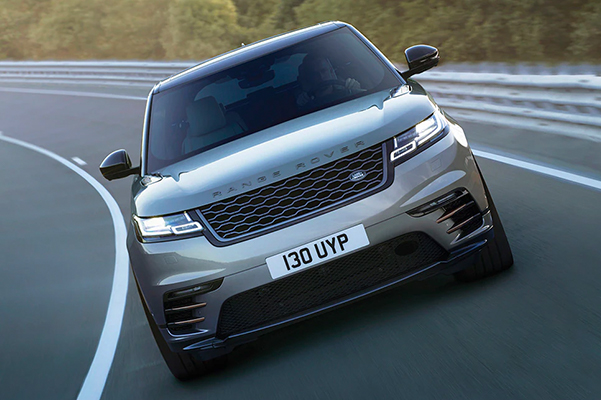 Exterior shot of a 2023 Range Rover Velar driving on a track,