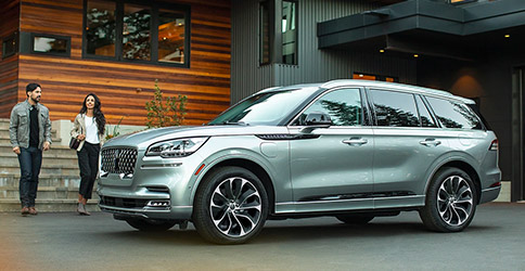 Side view of 2023 Lincoln Aviator with people walking towards it