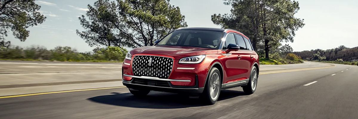A 2023 Lincoln Corsair® SUV is shown being driven in a rural setting