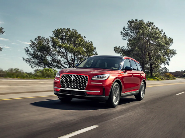 A 2023 Lincoln Corsair® SUV is shown being driven in a rural setting