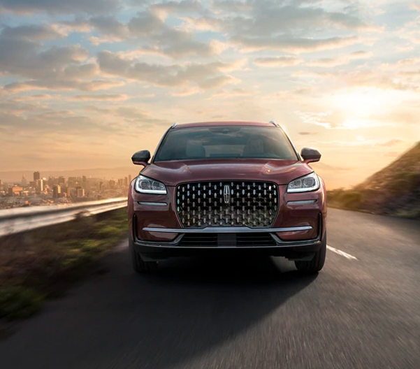 A 2023 Lincoln Corsair® SUV is shown being driven on a hillside road